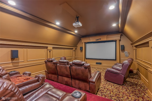 carpeted cinema with lofted ceiling and ornamental molding