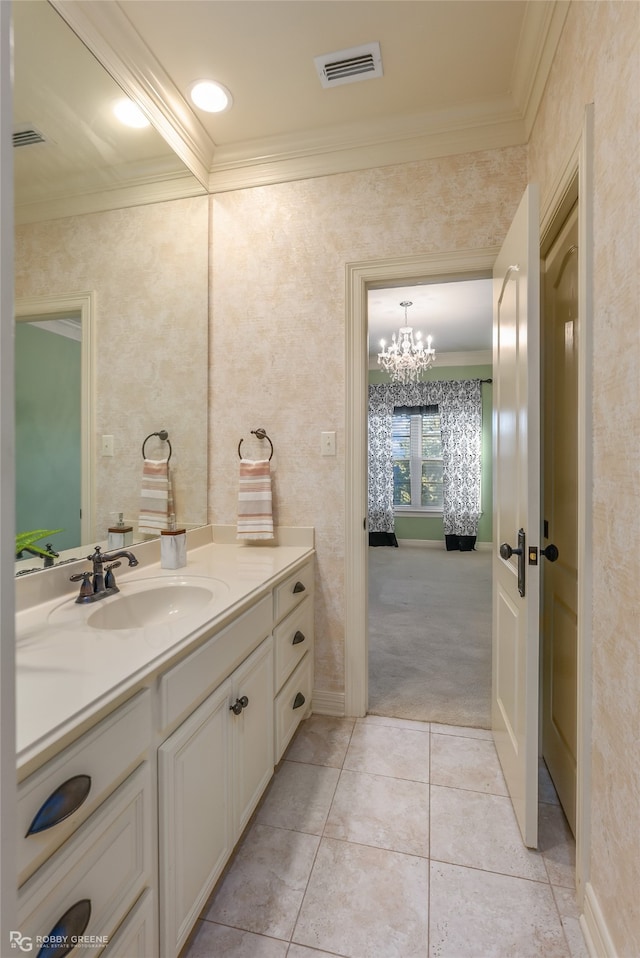 bathroom with tile patterned floors, vanity, crown molding, and an inviting chandelier