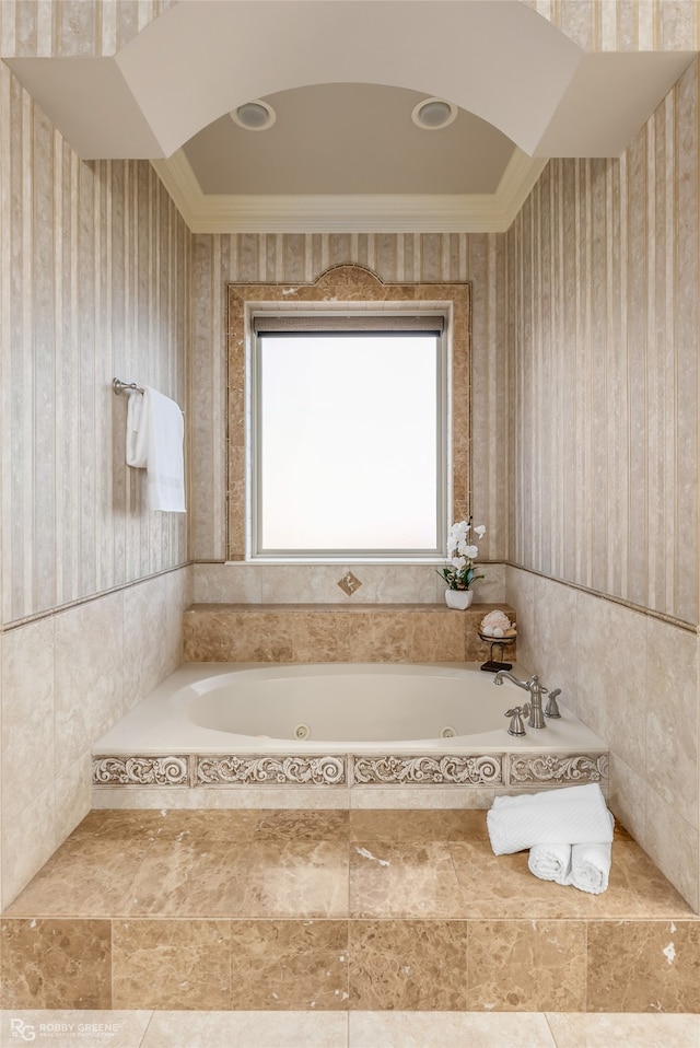 bathroom featuring ornamental molding and tiled bath