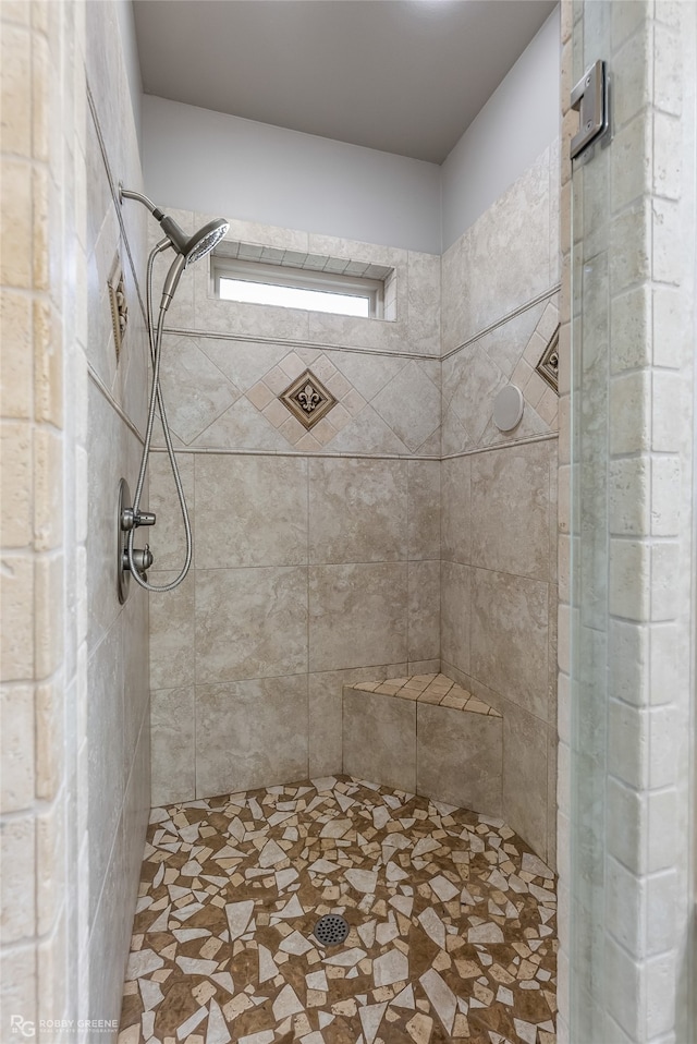 bathroom with a tile shower