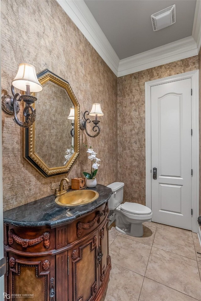 bathroom featuring tile patterned flooring, vanity, toilet, and crown molding