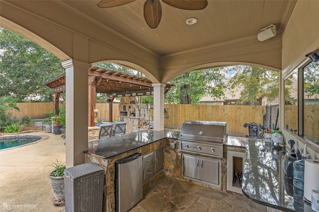 view of patio / terrace featuring a pergola, grilling area, ceiling fan, and an outdoor kitchen