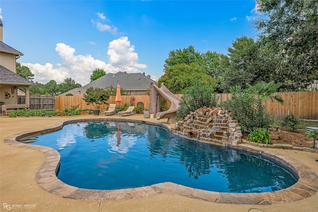 view of pool with a patio area and a water slide