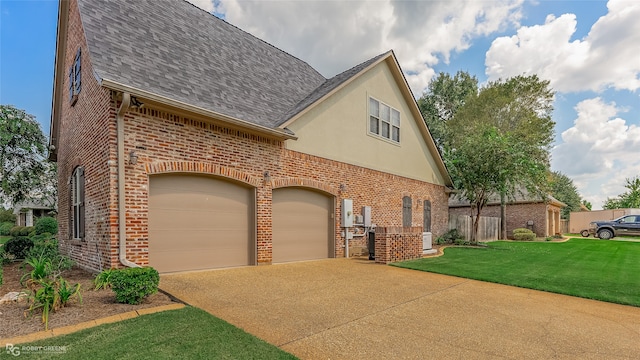 view of front of house featuring a garage and a front lawn