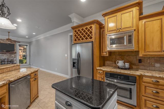 kitchen with dark stone countertops, decorative light fixtures, and appliances with stainless steel finishes