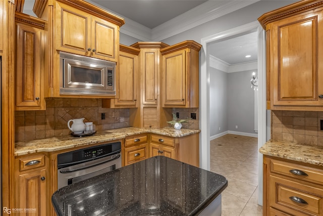 kitchen featuring stainless steel appliances, backsplash, crown molding, stone countertops, and light tile patterned flooring