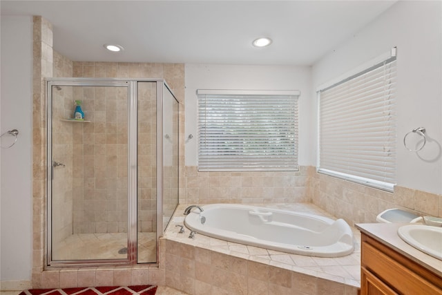 bathroom featuring a shower stall, recessed lighting, a bath, and vanity