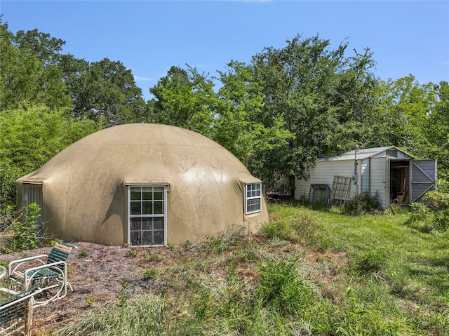 view of side of property featuring an outdoor structure