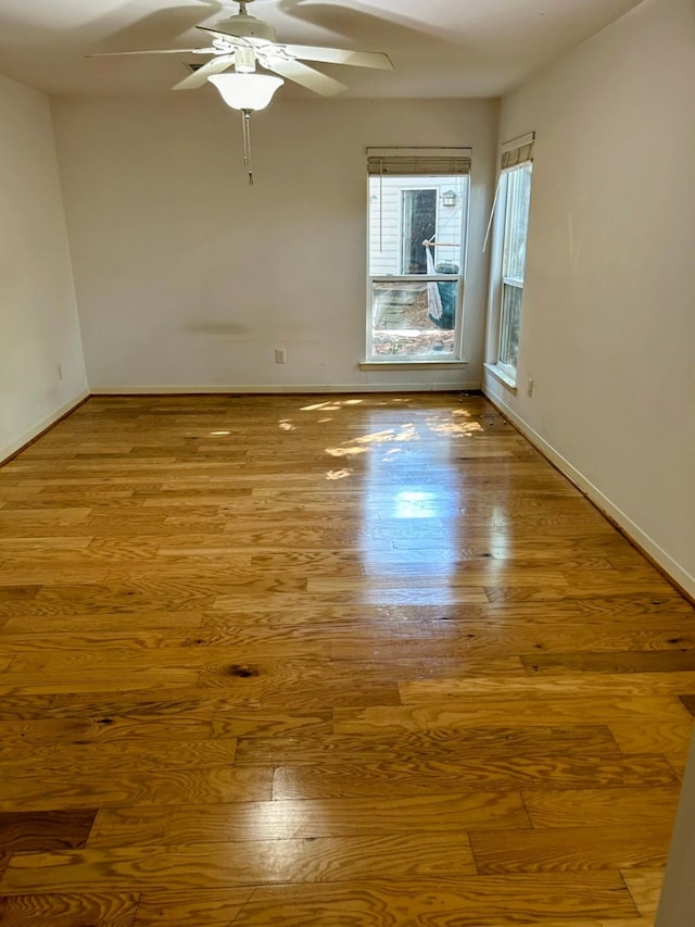 unfurnished room with light wood-type flooring and ceiling fan