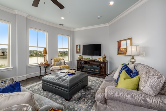 living room with crown molding, hardwood / wood-style floors, and ceiling fan