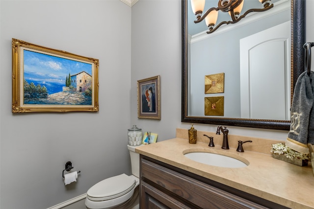 bathroom featuring crown molding, vanity, and toilet