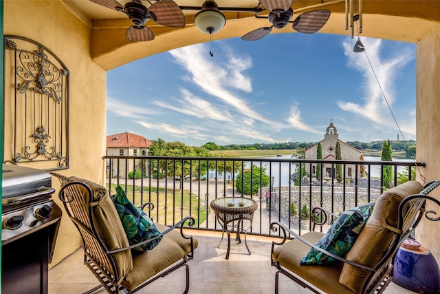 balcony with a water view, ceiling fan, and a grill