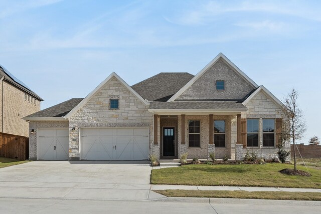 view of front of home with a yard and a garage