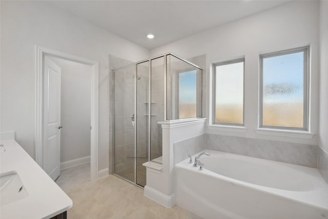 bathroom with vanity, independent shower and bath, and tile patterned flooring