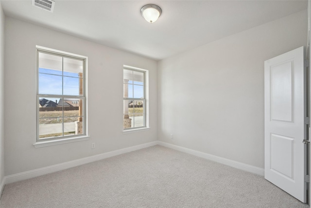 carpeted spare room with plenty of natural light