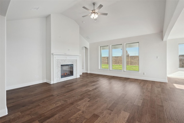 unfurnished living room featuring high vaulted ceiling, a tile fireplace, dark hardwood / wood-style floors, and ceiling fan