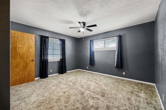 unfurnished room featuring carpet floors, a textured ceiling, and ceiling fan