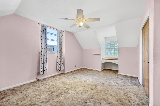 additional living space featuring lofted ceiling, cooling unit, ceiling fan, and carpet