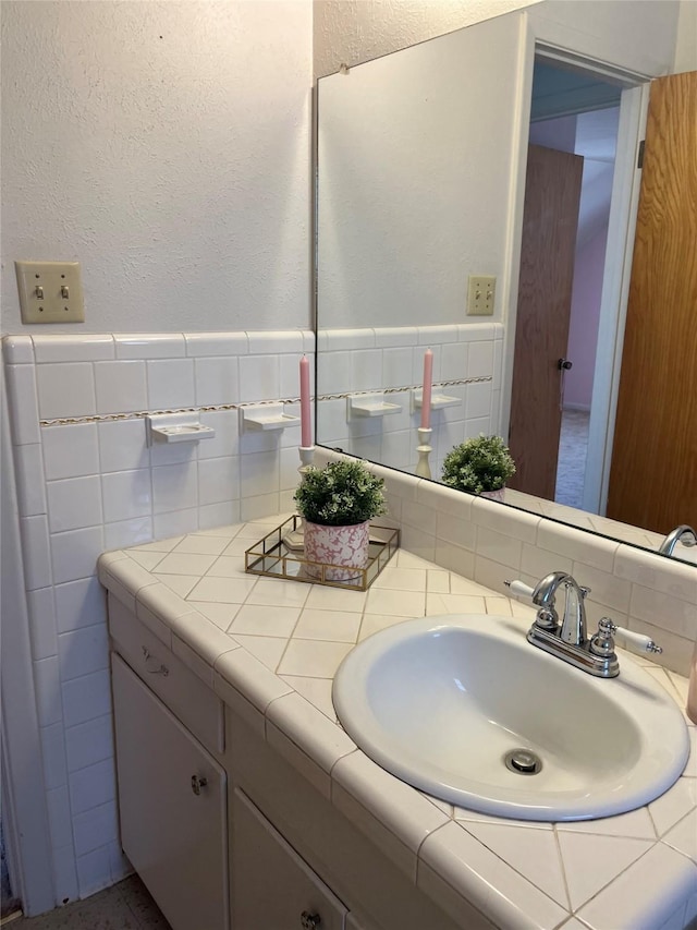 bathroom with vanity and tile walls