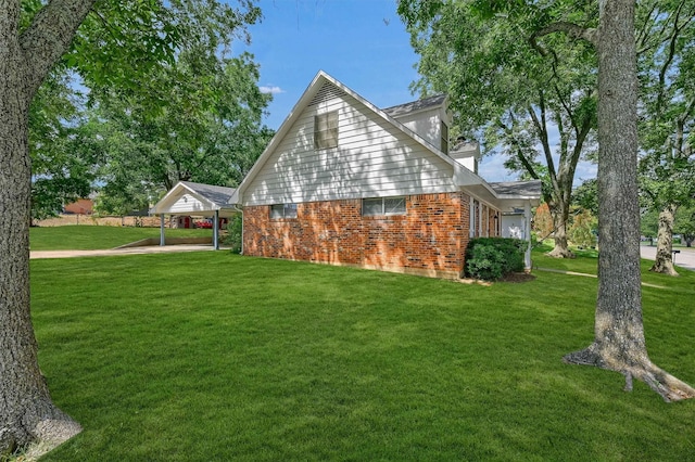 view of side of home featuring a lawn and a carport