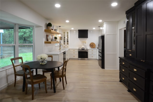 dining space featuring light wood-type flooring and sink