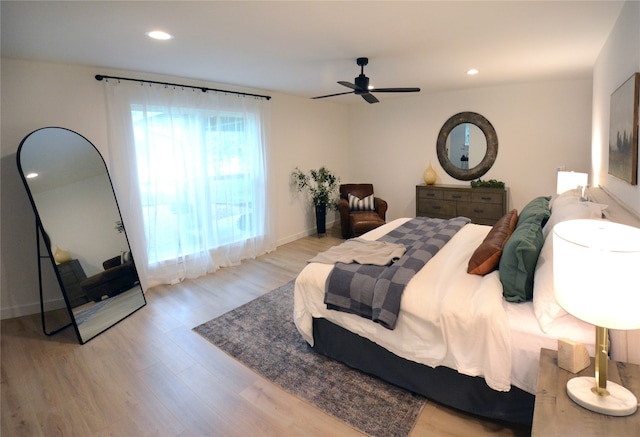 bedroom with ceiling fan and light hardwood / wood-style flooring