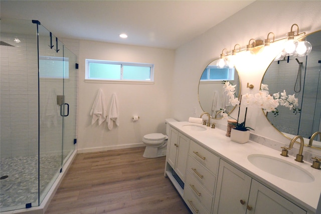 bathroom featuring walk in shower, vanity, toilet, and hardwood / wood-style flooring