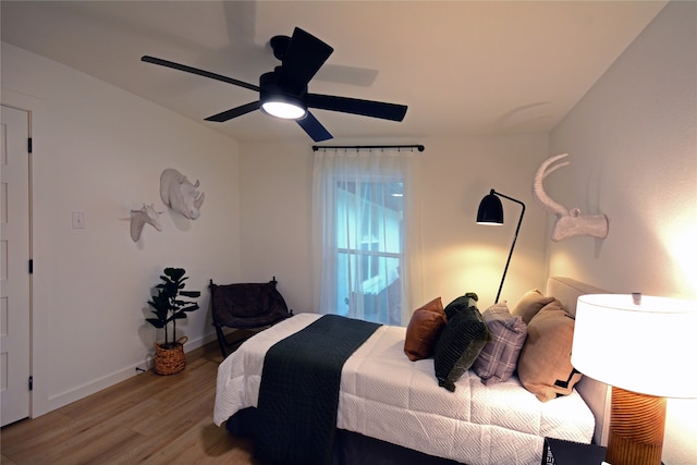 bedroom with ceiling fan and light hardwood / wood-style flooring