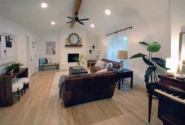 living room with ceiling fan, vaulted ceiling with beams, and light hardwood / wood-style flooring