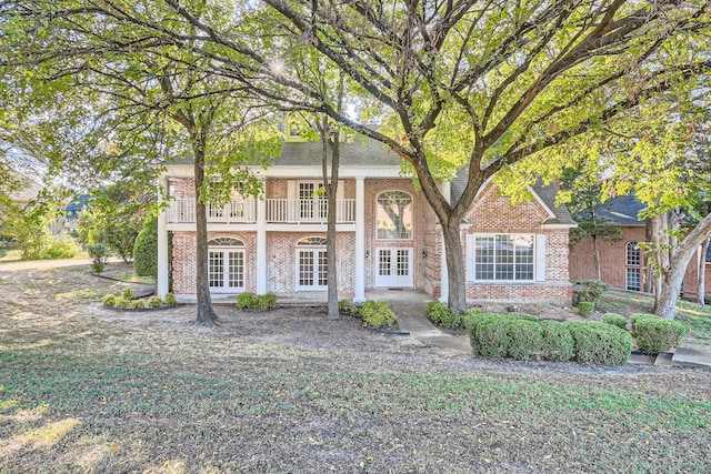 view of front facade featuring french doors and a balcony