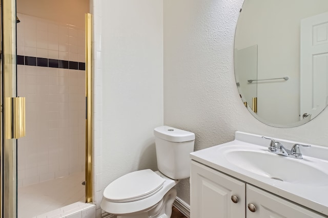 bathroom featuring vanity, toilet, and an enclosed shower