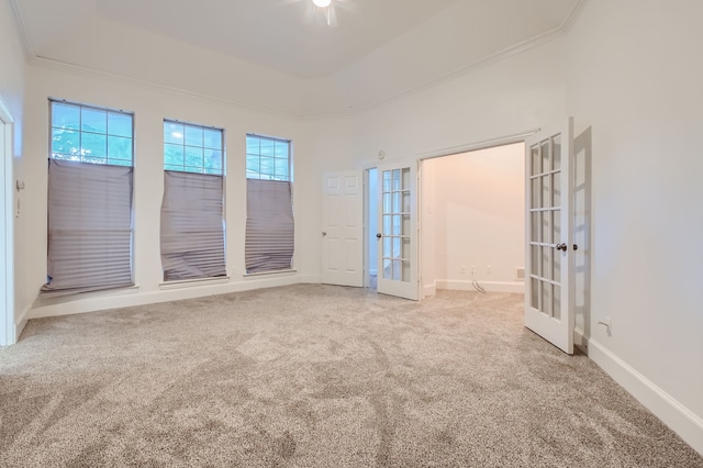 unfurnished room featuring carpet, french doors, and plenty of natural light