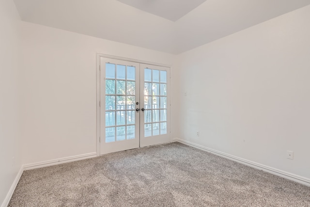 carpeted empty room featuring french doors