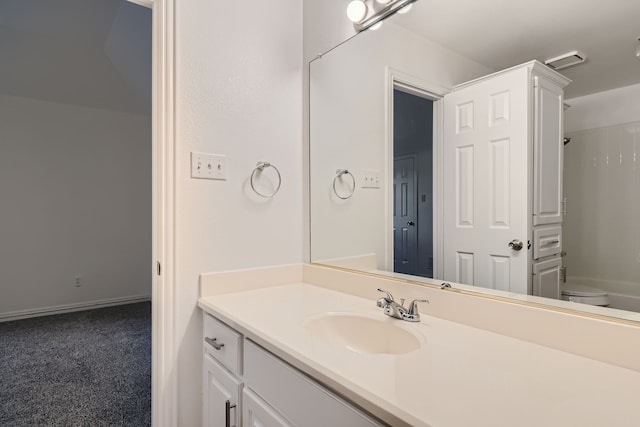 bathroom featuring vanity, a shower, and toilet