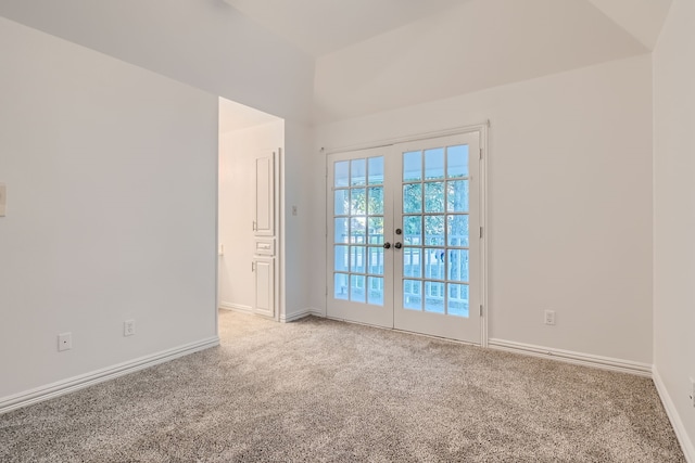 carpeted empty room featuring french doors