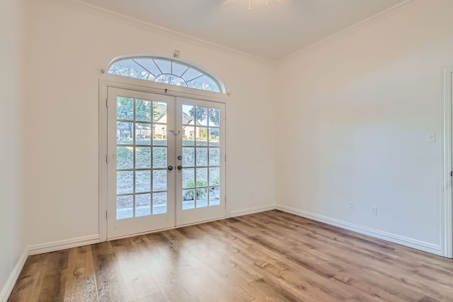 entryway featuring crown molding, light hardwood / wood-style floors, and french doors