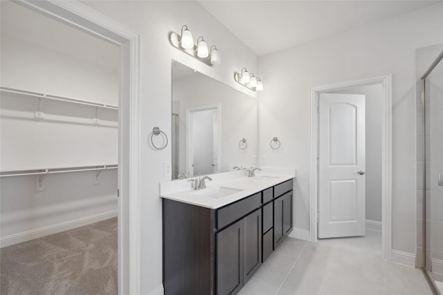 2805 Spring Valley Dr, Anna, TX 75409 - full bath featuring double vanity, tiled shower, a spacious closet, and tile patterned flooring