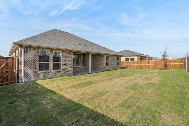 back of house featuring a lawn