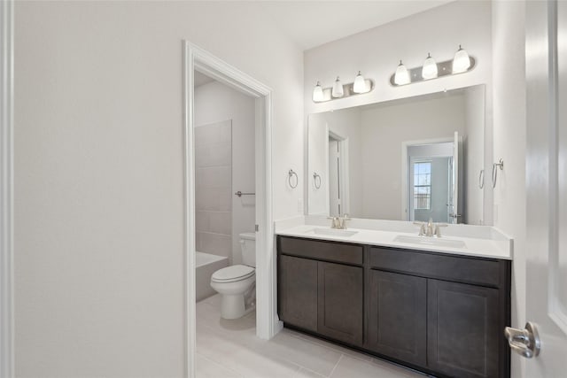 full bathroom featuring toilet, vanity,  shower combination, and tile patterned flooring