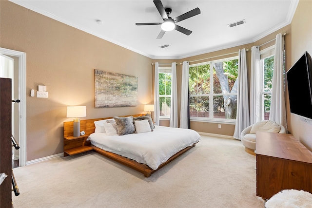 carpeted bedroom with ornamental molding and ceiling fan