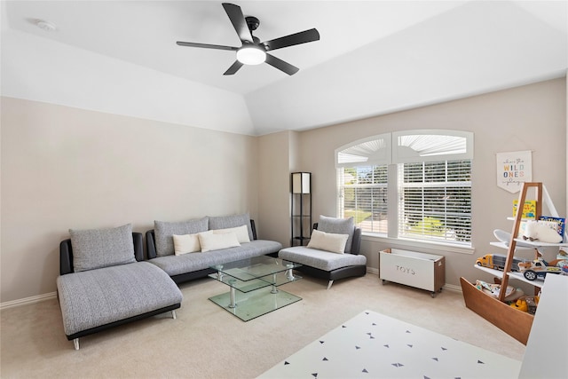 living room with light colored carpet, ceiling fan, and vaulted ceiling