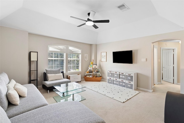 carpeted living room featuring ceiling fan and a tray ceiling