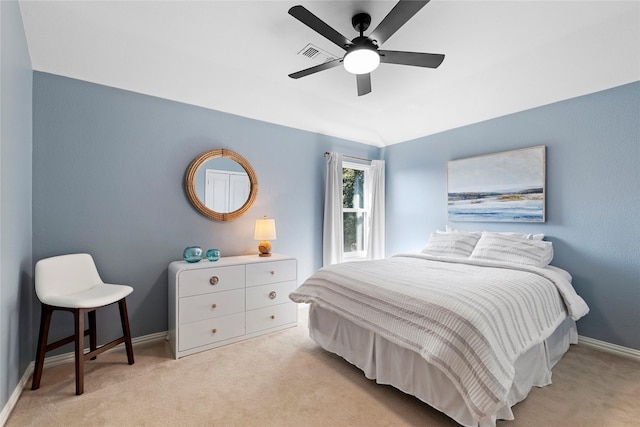 bedroom featuring lofted ceiling, light colored carpet, and ceiling fan