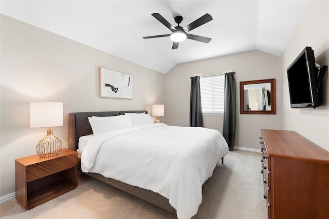 carpeted bedroom featuring ceiling fan and vaulted ceiling