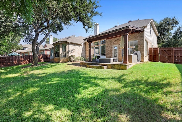 back of house featuring an outdoor hangout area, a patio, and a yard