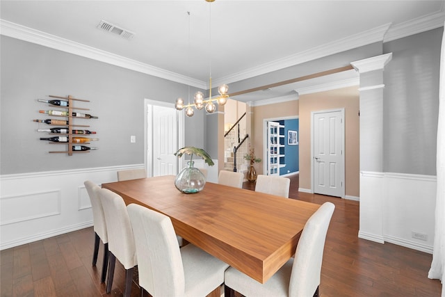 dining room with dark hardwood / wood-style flooring, a chandelier, and crown molding