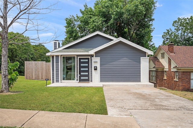 bungalow-style home with a front lawn