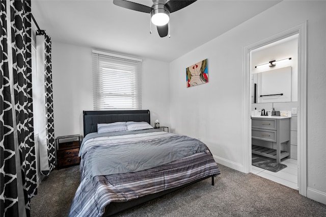 carpeted bedroom with ceiling fan and ensuite bath