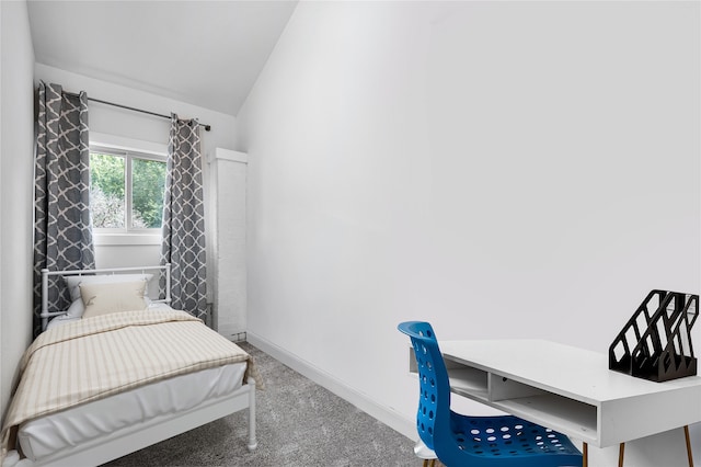 bedroom featuring lofted ceiling and carpet flooring