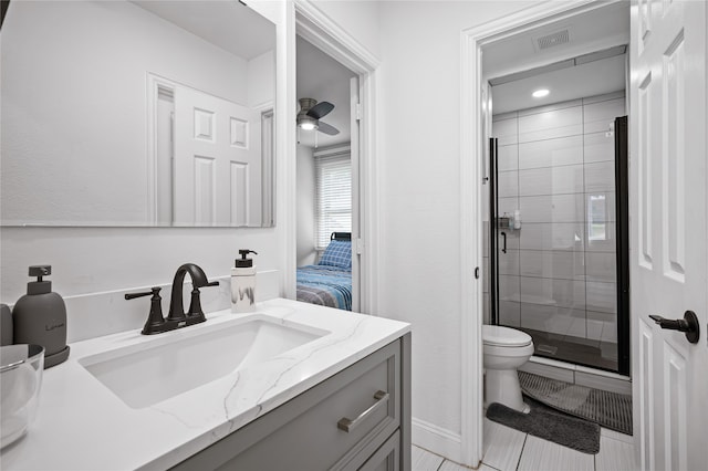 bathroom with ceiling fan, vanity, toilet, walk in shower, and tile patterned flooring